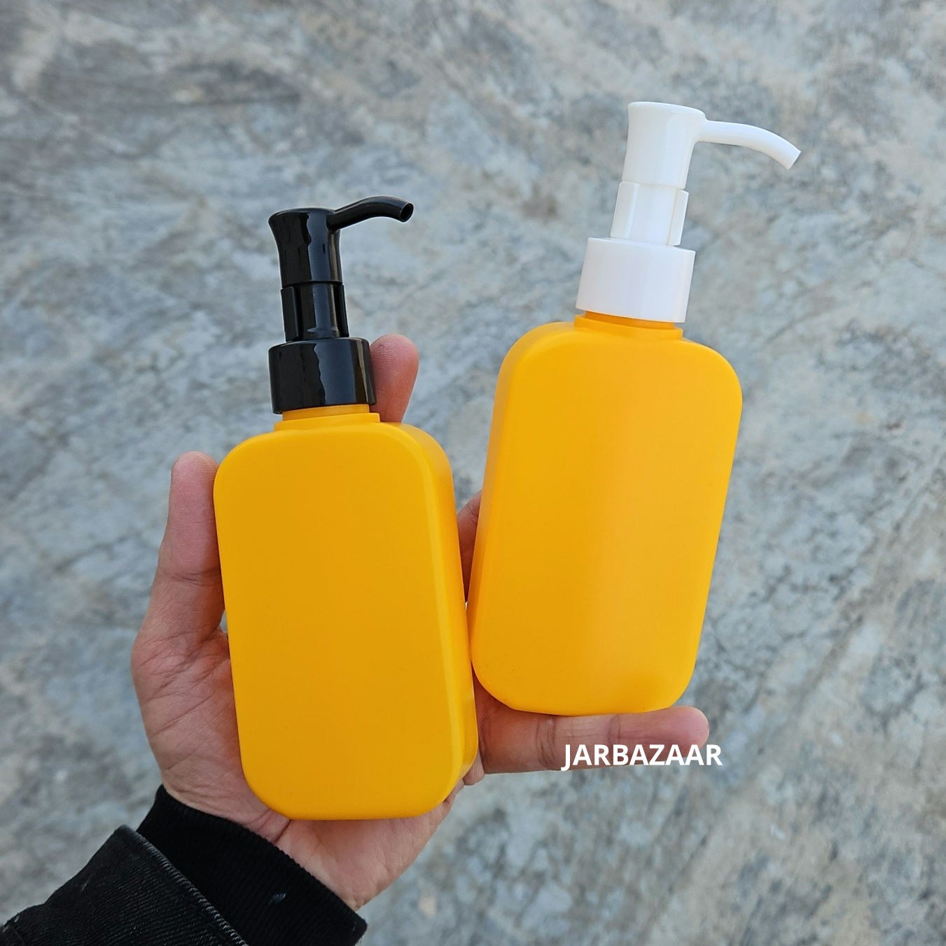 125 ML flat orange HDPE bottle with black and white sleek dispenser pumps